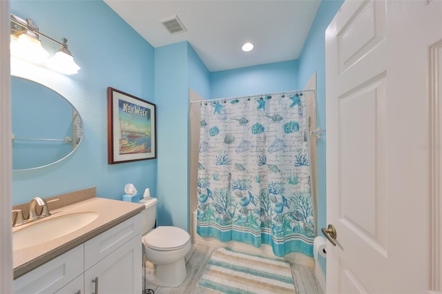 bathroom with toilet, shower / tub combo, wood finished floors, vanity, and visible vents