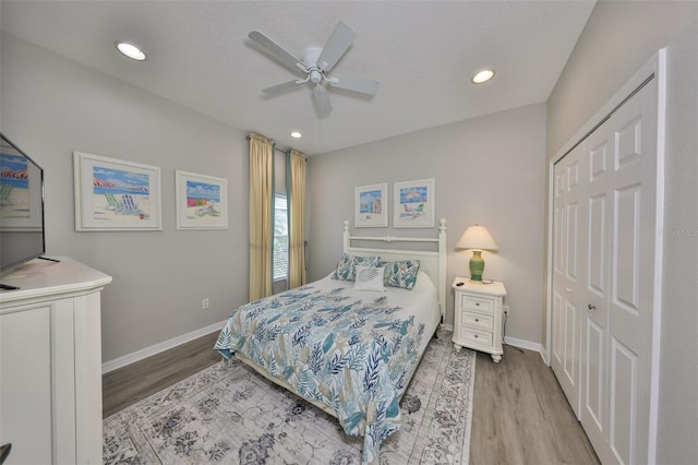 bedroom with light wood-type flooring, baseboards, and recessed lighting