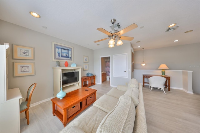 living area featuring light wood finished floors, visible vents, and recessed lighting