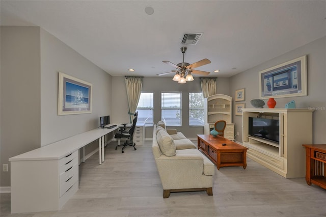 office space with recessed lighting, visible vents, ceiling fan, and light wood-style flooring