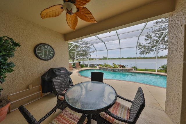 pool featuring ceiling fan, a patio, a lanai, a water view, and a grill