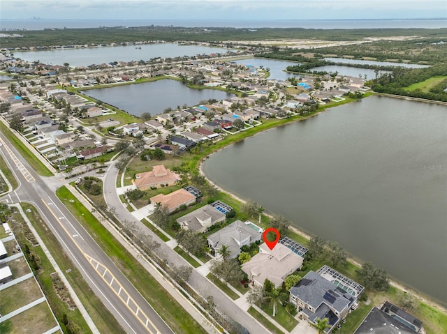 birds eye view of property with a water view and a residential view