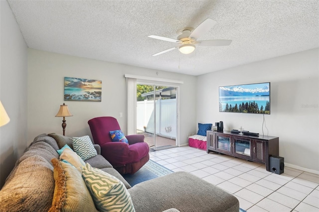 living area with ceiling fan, a textured ceiling, baseboards, and light tile patterned floors