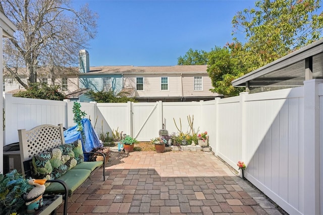 view of patio featuring a fenced backyard and a gate