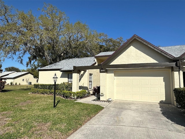 ranch-style house featuring a garage, driveway, a front lawn, and stucco siding