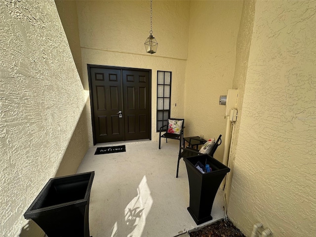 entrance to property featuring stucco siding