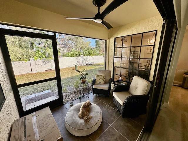 sunroom featuring a ceiling fan