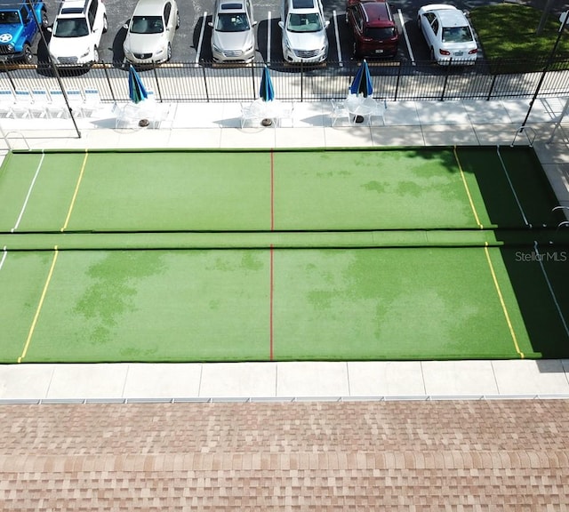 view of tennis court featuring fence