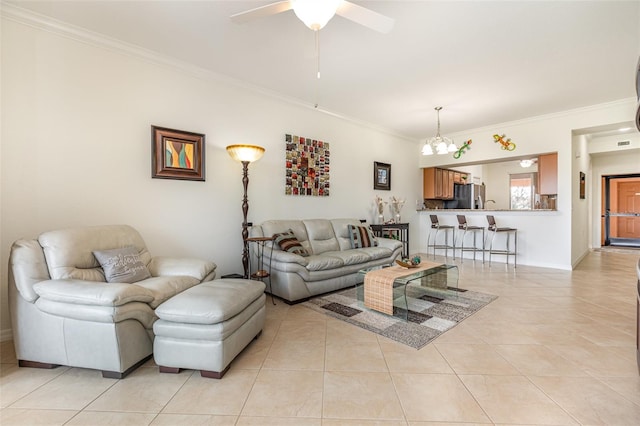 living area with ornamental molding, ceiling fan, and light tile patterned floors