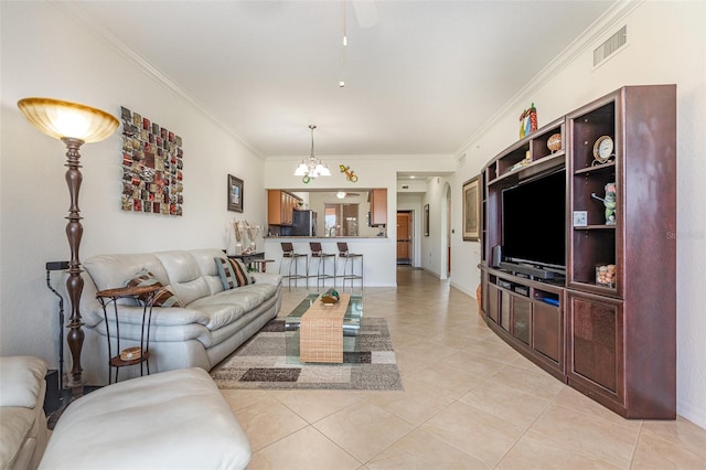 living area with a chandelier, visible vents, crown molding, and light tile patterned floors