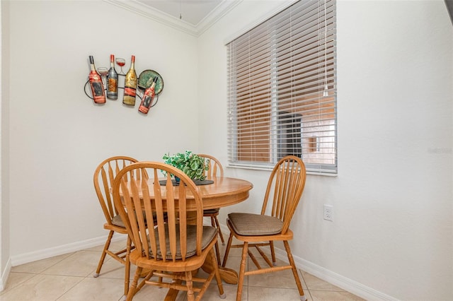 dining room featuring ornamental molding, baseboards, and light tile patterned floors