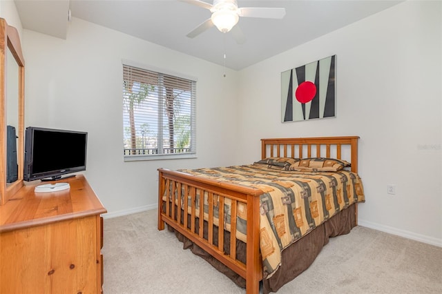 bedroom with light carpet, ceiling fan, and baseboards