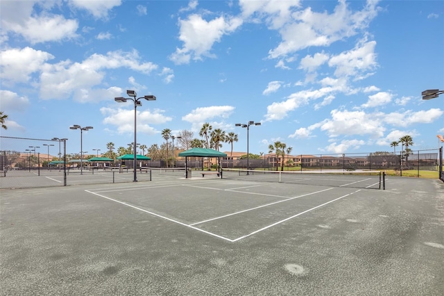 view of tennis court featuring fence