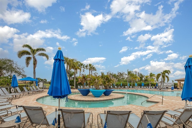 community pool with a patio area