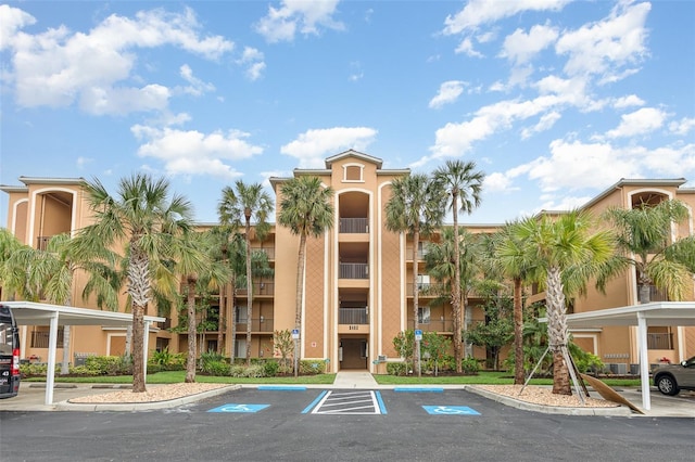 view of building exterior featuring uncovered parking