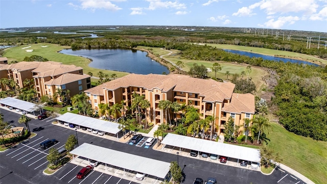 bird's eye view with a water view and golf course view