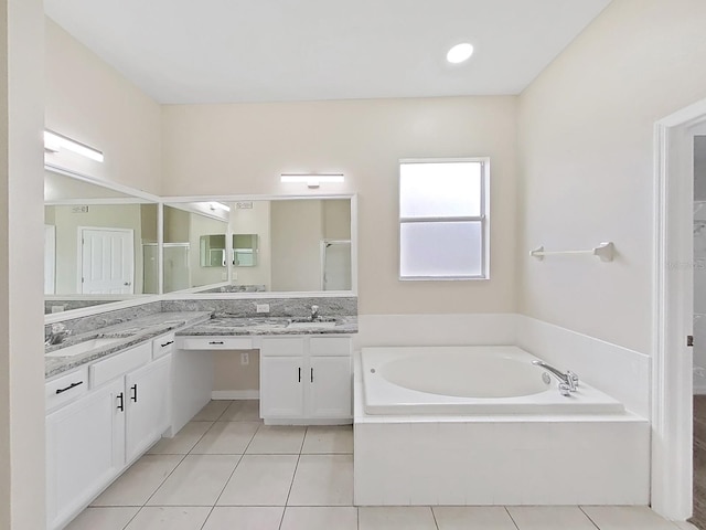 full bath with tile patterned flooring, walk in shower, vanity, and a bath