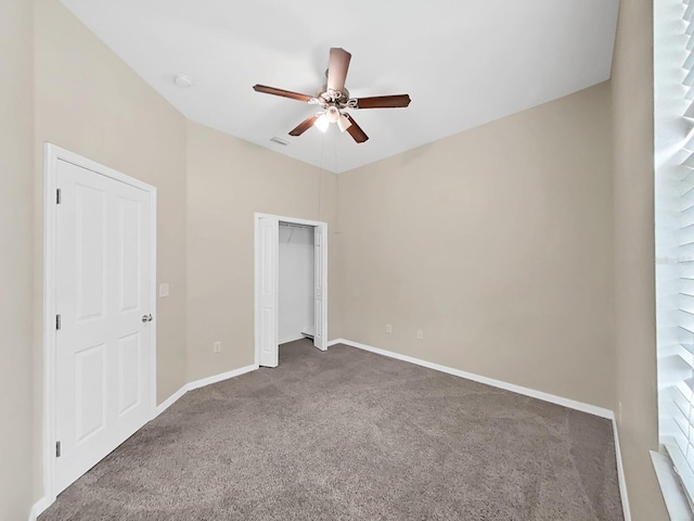 interior space with carpet floors, a closet, baseboards, and a ceiling fan