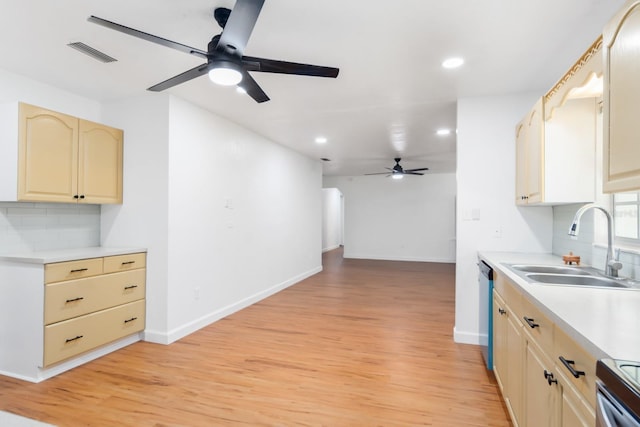 kitchen featuring a sink, visible vents, light wood-style floors, light countertops, and stainless steel dishwasher