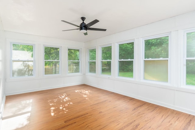 unfurnished sunroom featuring ceiling fan