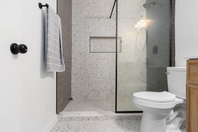 bathroom featuring toilet and tiled shower