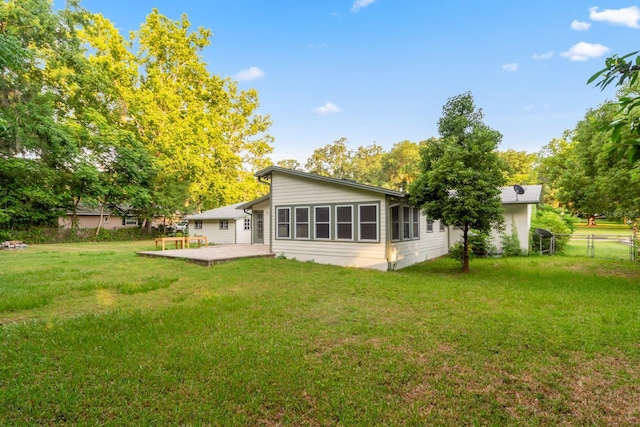 back of house featuring a patio, fence, and a lawn