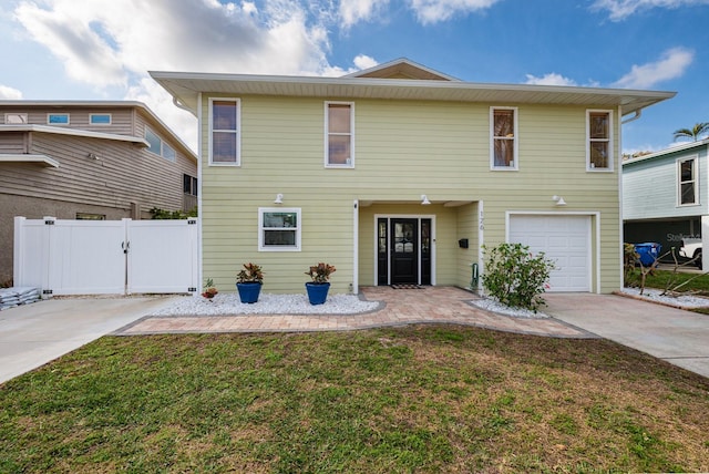 view of front facade with a garage, fence, concrete driveway, and a front yard