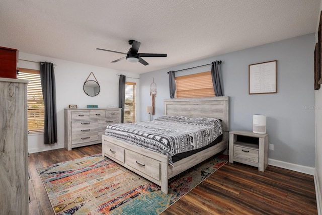 bedroom with wood-type flooring, baseboards, and a textured ceiling