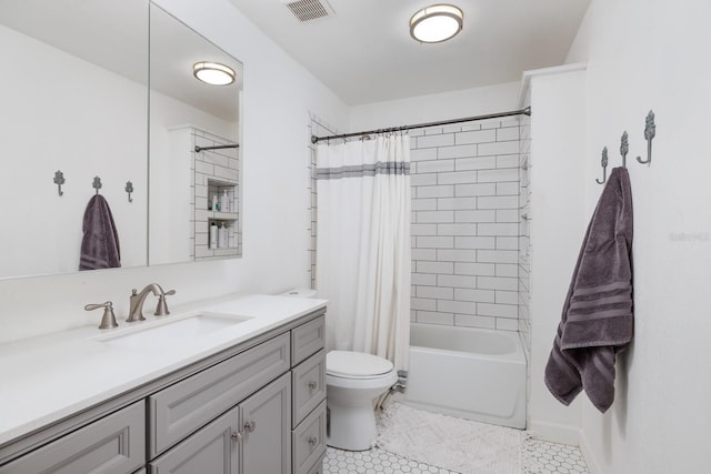 bathroom with toilet, tile patterned flooring, visible vents, and vanity