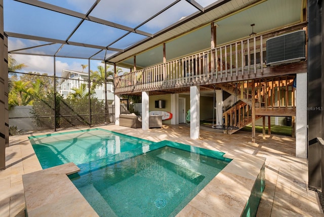 outdoor pool featuring a lanai, a patio area, stairway, and a deck