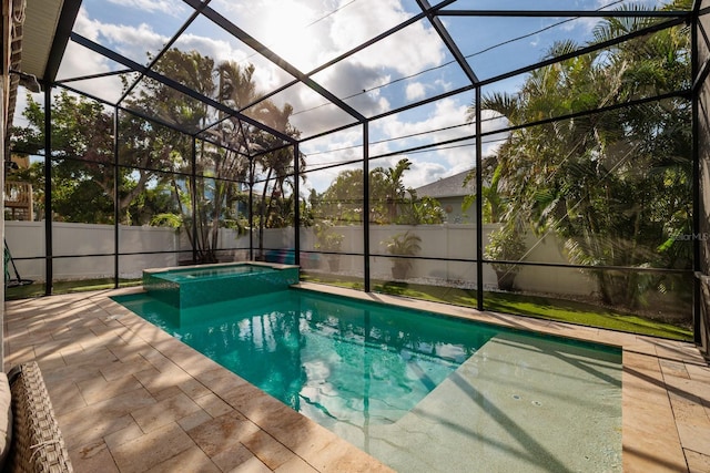 view of swimming pool with a patio, a fenced backyard, a lanai, and a pool with connected hot tub