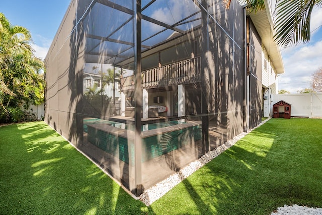 view of side of property with a lanai, an outdoor pool, a patio, and a yard