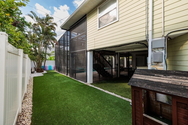 view of yard featuring a lanai and a fenced backyard