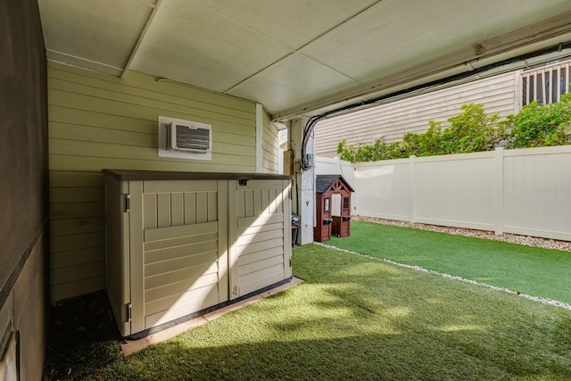 view of yard featuring fence and a wall mounted air conditioner