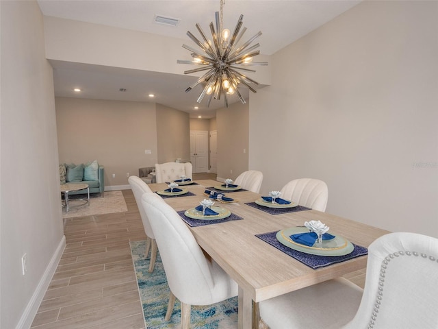 dining area with recessed lighting, wood finish floors, visible vents, baseboards, and an inviting chandelier