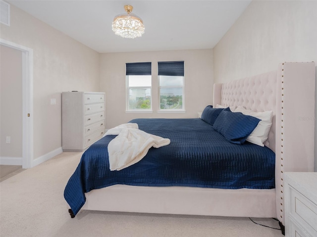 bedroom featuring light carpet, an inviting chandelier, visible vents, and baseboards