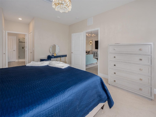 bedroom featuring ensuite bathroom, light colored carpet, a notable chandelier, visible vents, and baseboards