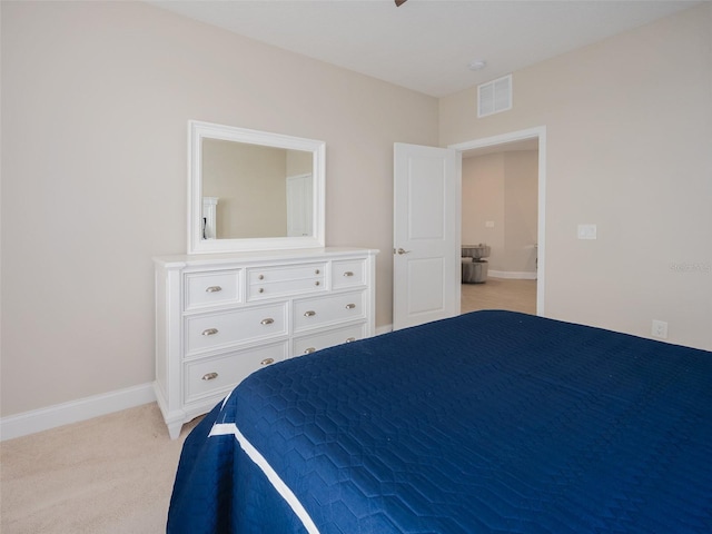 bedroom with visible vents, light carpet, and baseboards