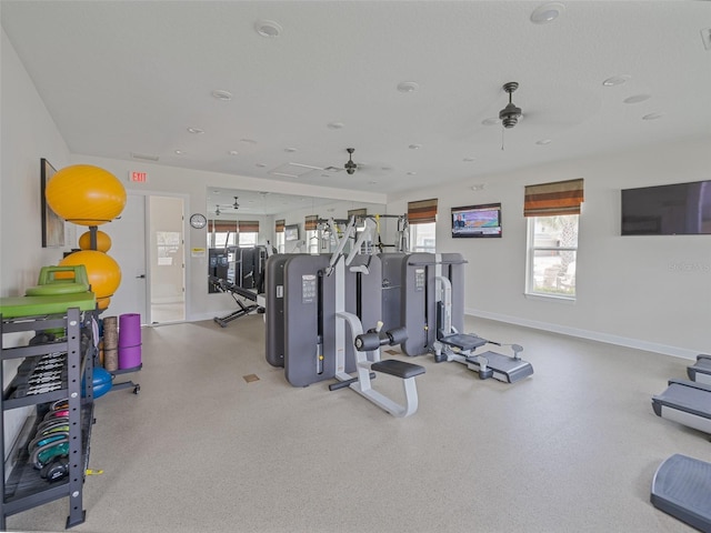 exercise room featuring visible vents, ceiling fan, and baseboards