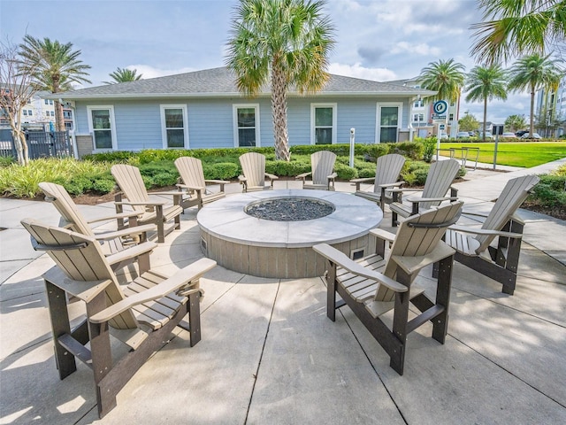 view of patio featuring a fire pit and fence