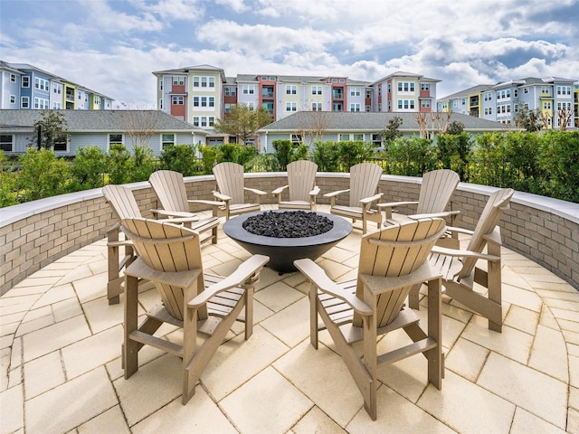 view of patio with an outdoor fire pit and a residential view