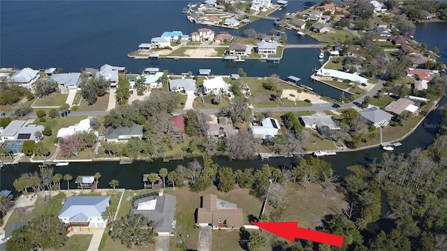 drone / aerial view featuring a water view and a residential view