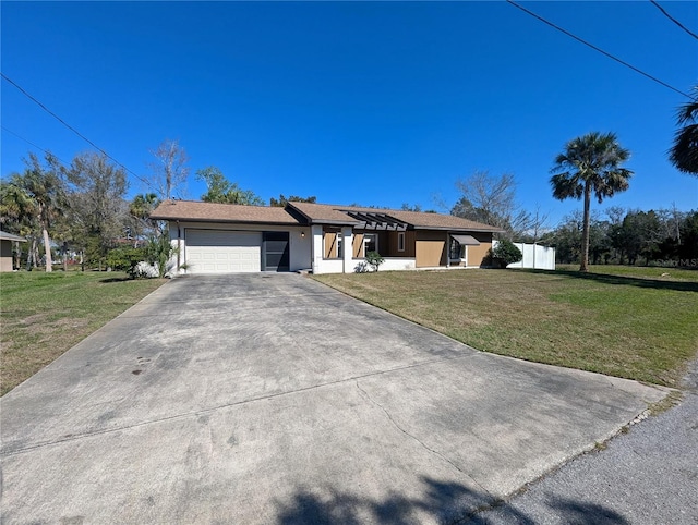 view of front of property featuring a garage, driveway, a front lawn, and fence