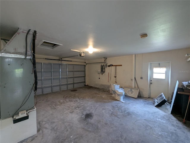 garage featuring a garage door opener and electric panel