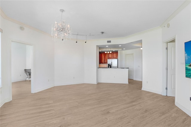 unfurnished living room featuring a chandelier, recessed lighting, baseboards, ornamental molding, and light wood finished floors