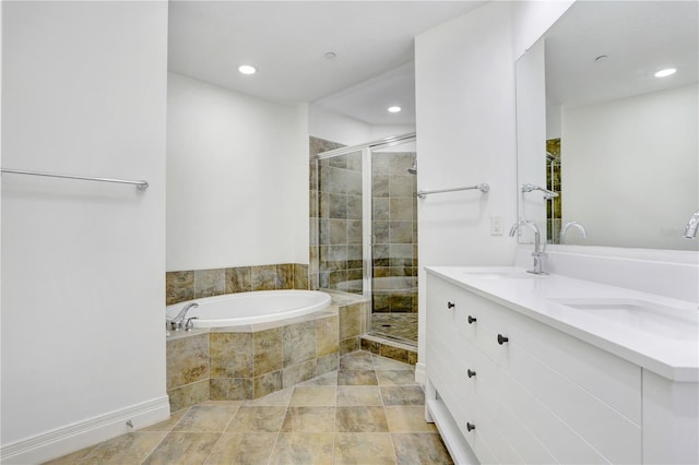 bathroom featuring a bath, a stall shower, and a sink