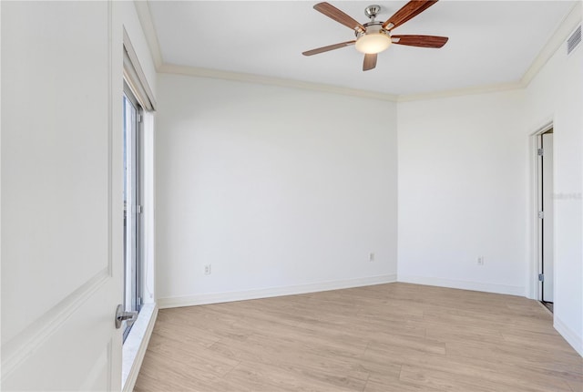 unfurnished room with light wood-type flooring, baseboards, visible vents, and crown molding