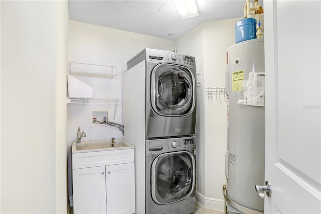 clothes washing area with cabinet space, stacked washer / dryer, and electric water heater