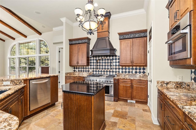 kitchen featuring stone finish flooring, appliances with stainless steel finishes, backsplash, and stone countertops