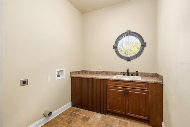 bathroom with vanity, stone tile flooring, and baseboards